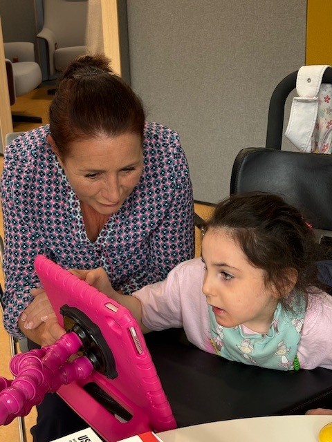 A young girl is using an iPad provided by Lifelites to Laura Lynn Children's Hospice, with support from The Wooden Spoon Charity.