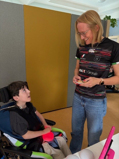 Rachel Murphy from the Wooden Spoon Charity visiting Laura Lynn Children's Hospice in Ireland to see Lifelites assistive technology in use by a young boy.